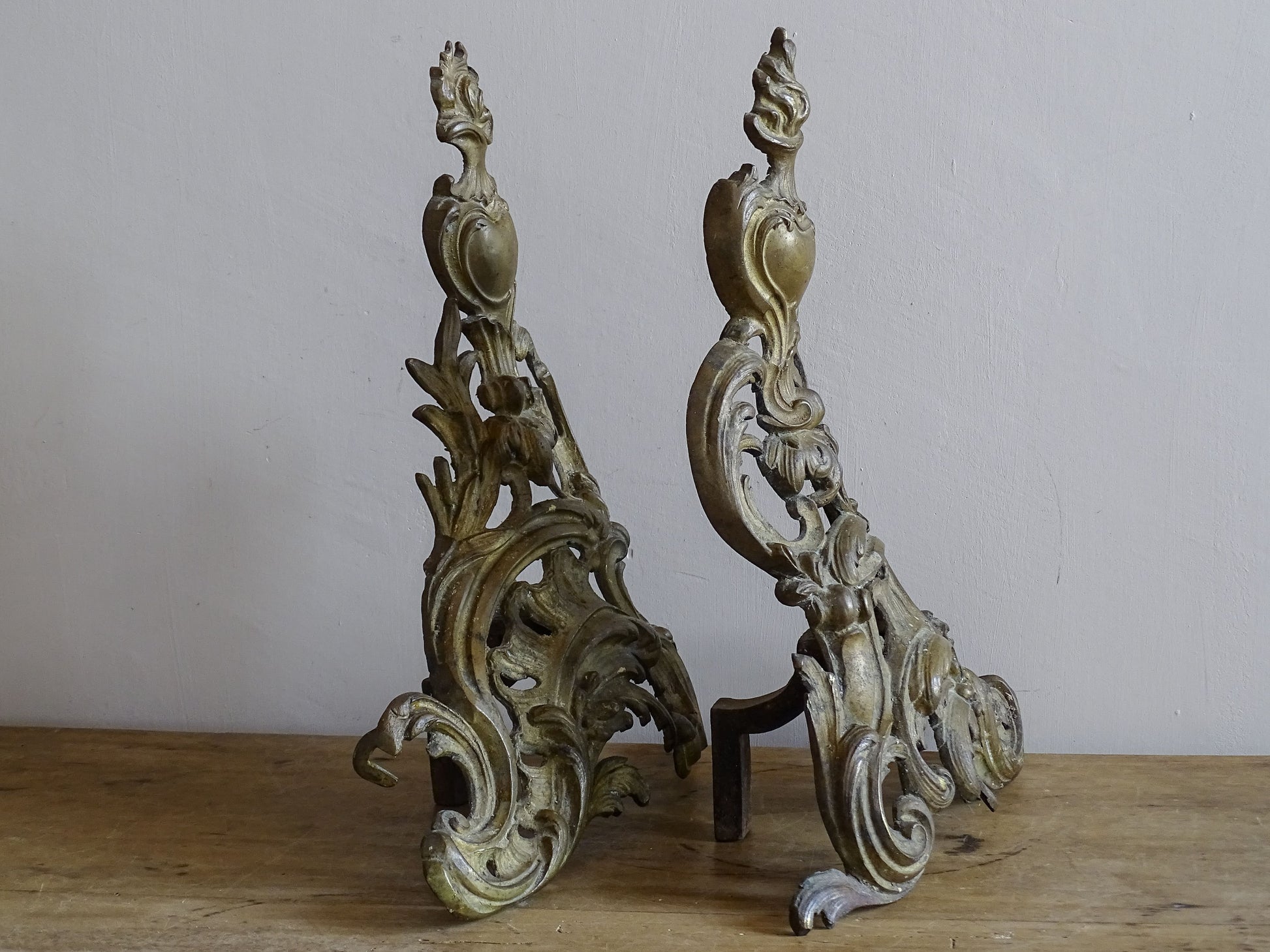 French gilt metal fireplace andirons with iron supports and aged patina