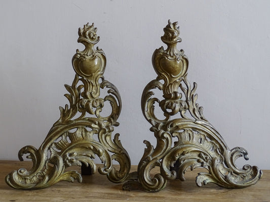 Pair of antique French gilt brass andirons with ornate Rococo decoration