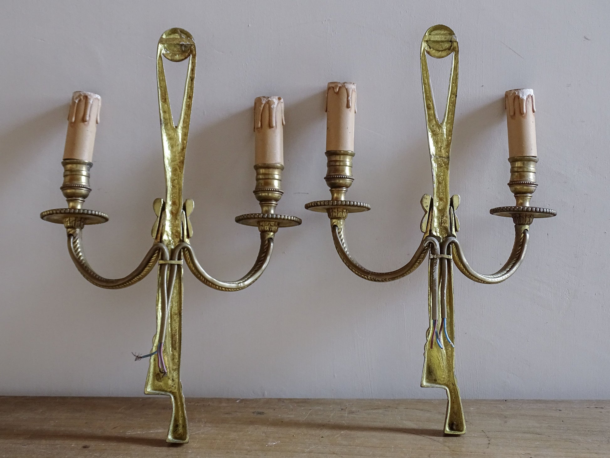 Vintage French tassel wall sconces with aged patina finish