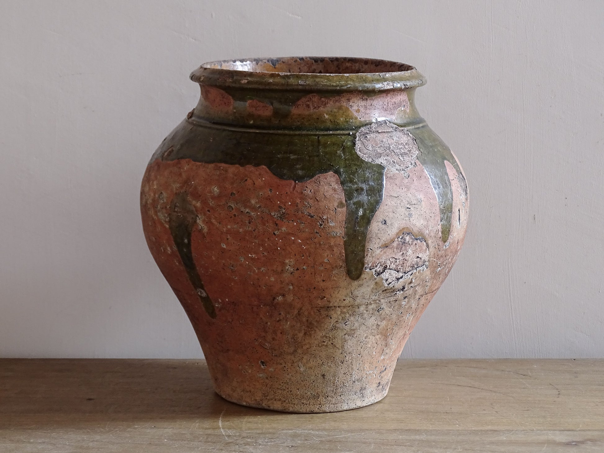 Antique French glazed earthenware jar with historic handle losses and rustic patina