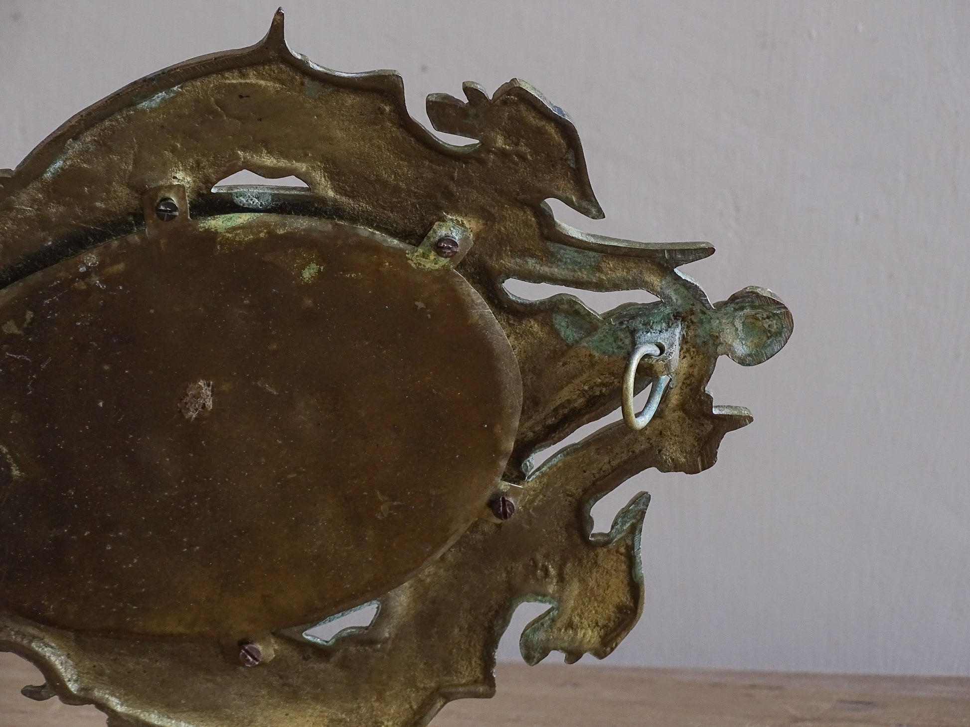 Antique French wall candle holder with mirror, cherub crest and decorative acanthus scrollwork.