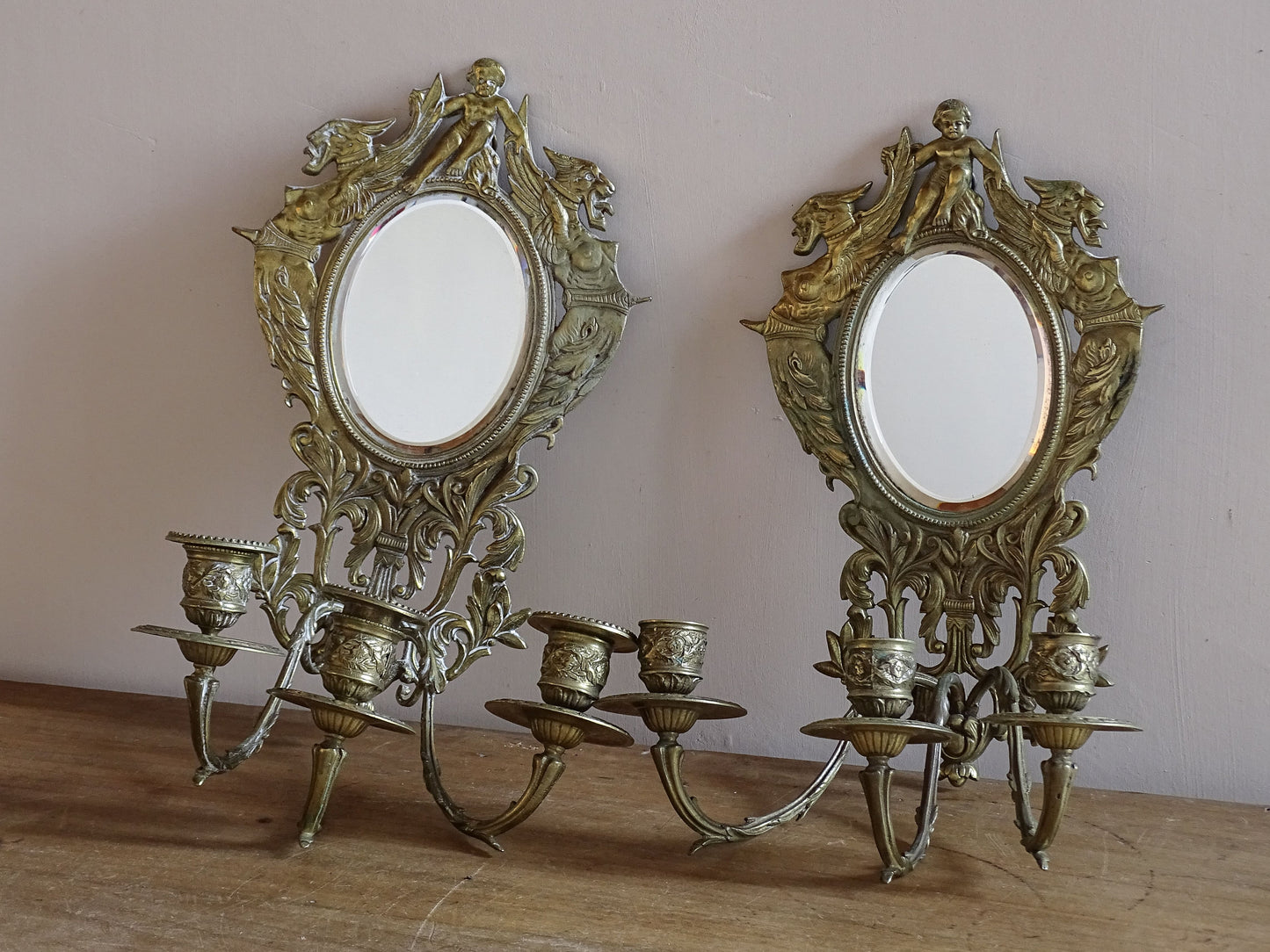 Pair of late nineteenth century French mirror wall sconces with three candle holders and gilt brass finish.