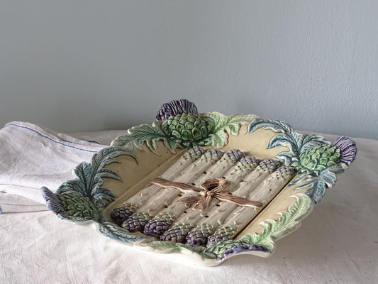 French antique barbotine ceramic asparagus plate, displayed with antique linen