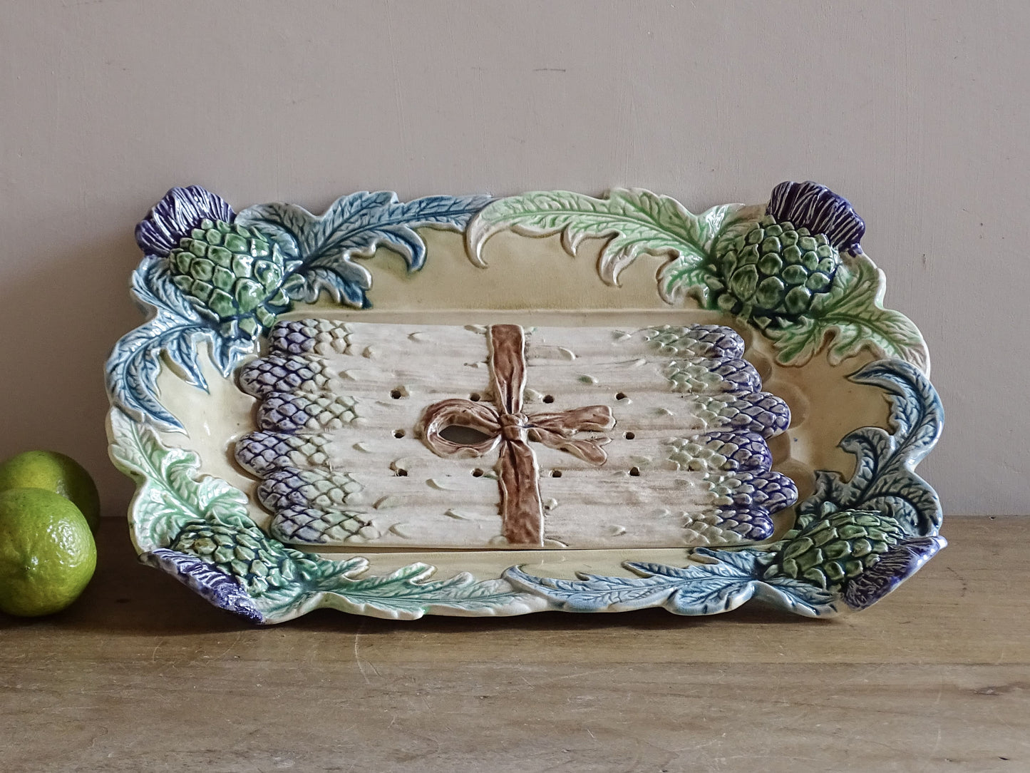 Antique French barbotine asparagus serving dish with removable drainer insert and artichoke decoration.