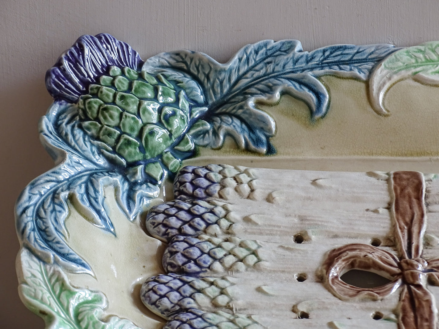 Late 19th century French barbotine asparagus platter with sculpted artichokes and asparagus drainer.