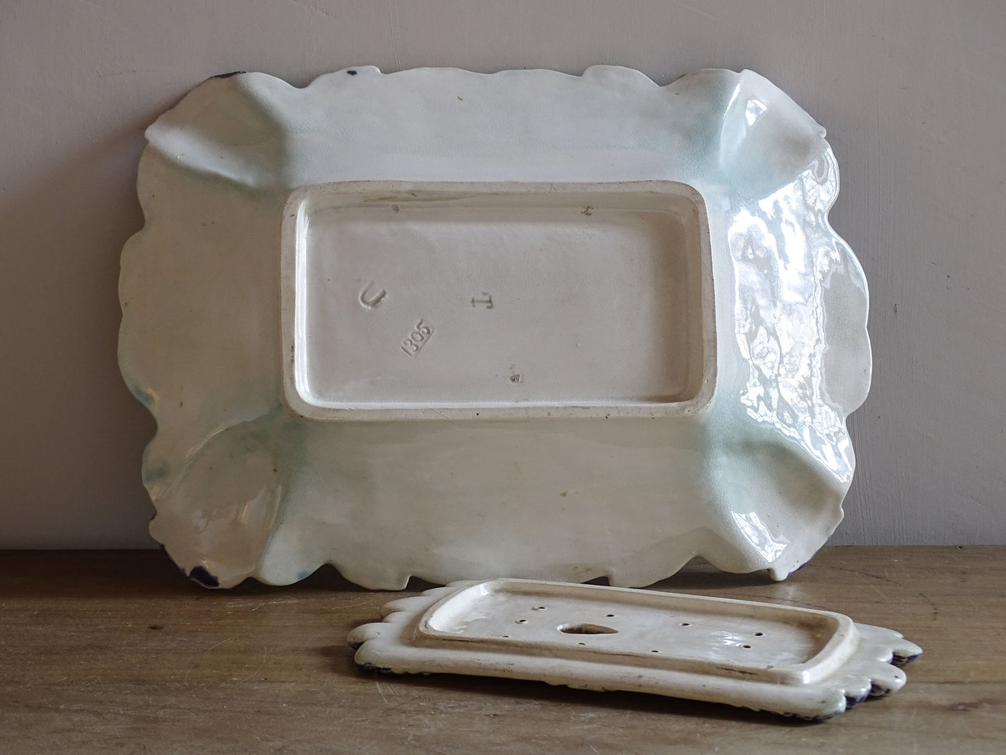 Detailed view of moulded artichoke decoration on an antique French barbotine asparagus serving dish.