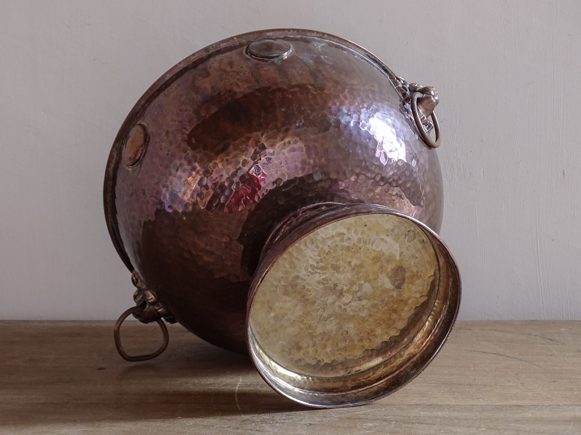 Interior view of an antique copper wine cooler showing aged patina and authentic wear.