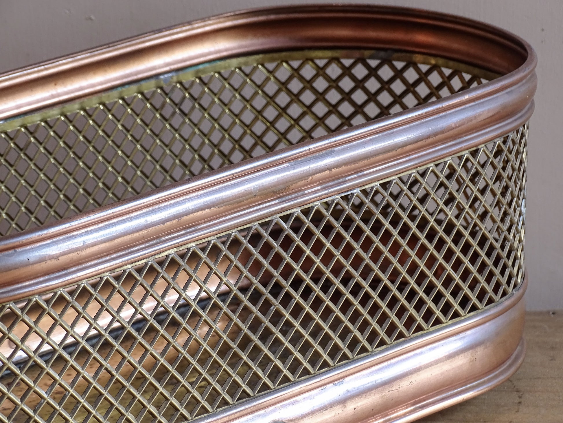 Vintage brass planter with elongated oval shape and raised feet