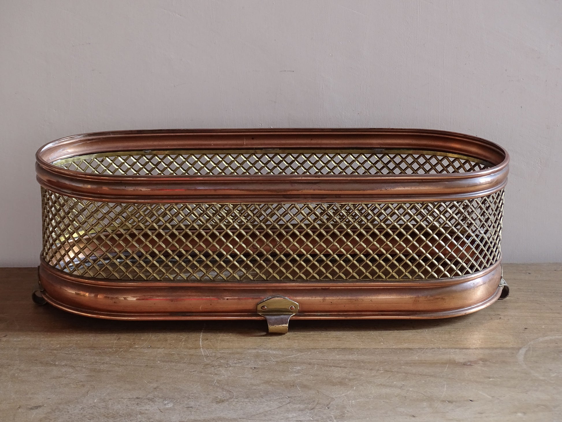 Mid 20th century brass mesh jardinière with copper-toned frame