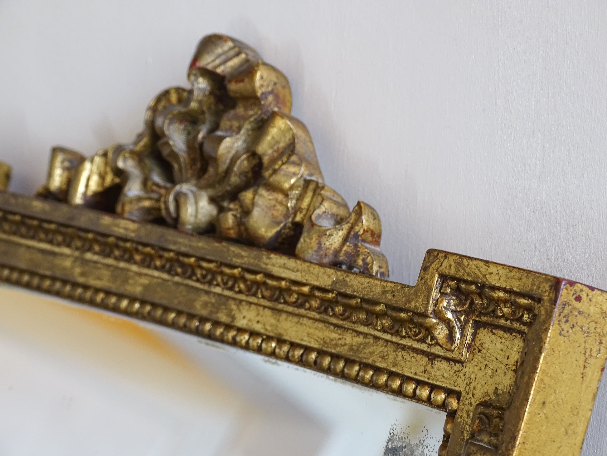 Detail of the gilded frame showing original patina and decorative moulding