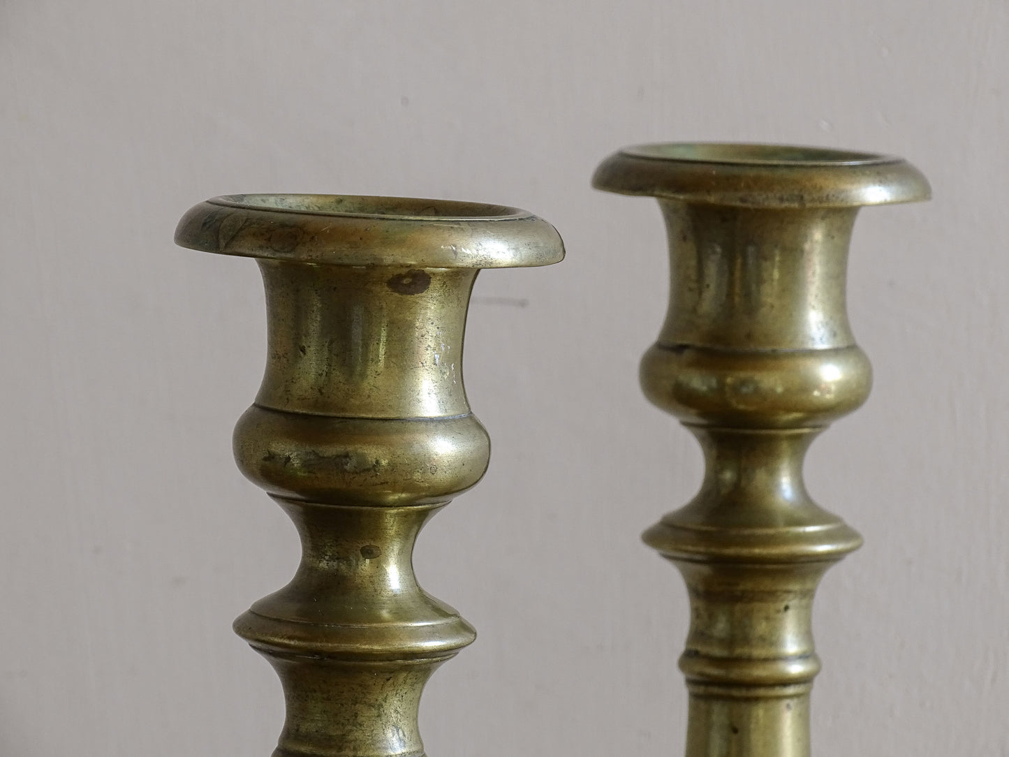 Early 20th century brass candlesticks with classic baluster stems.