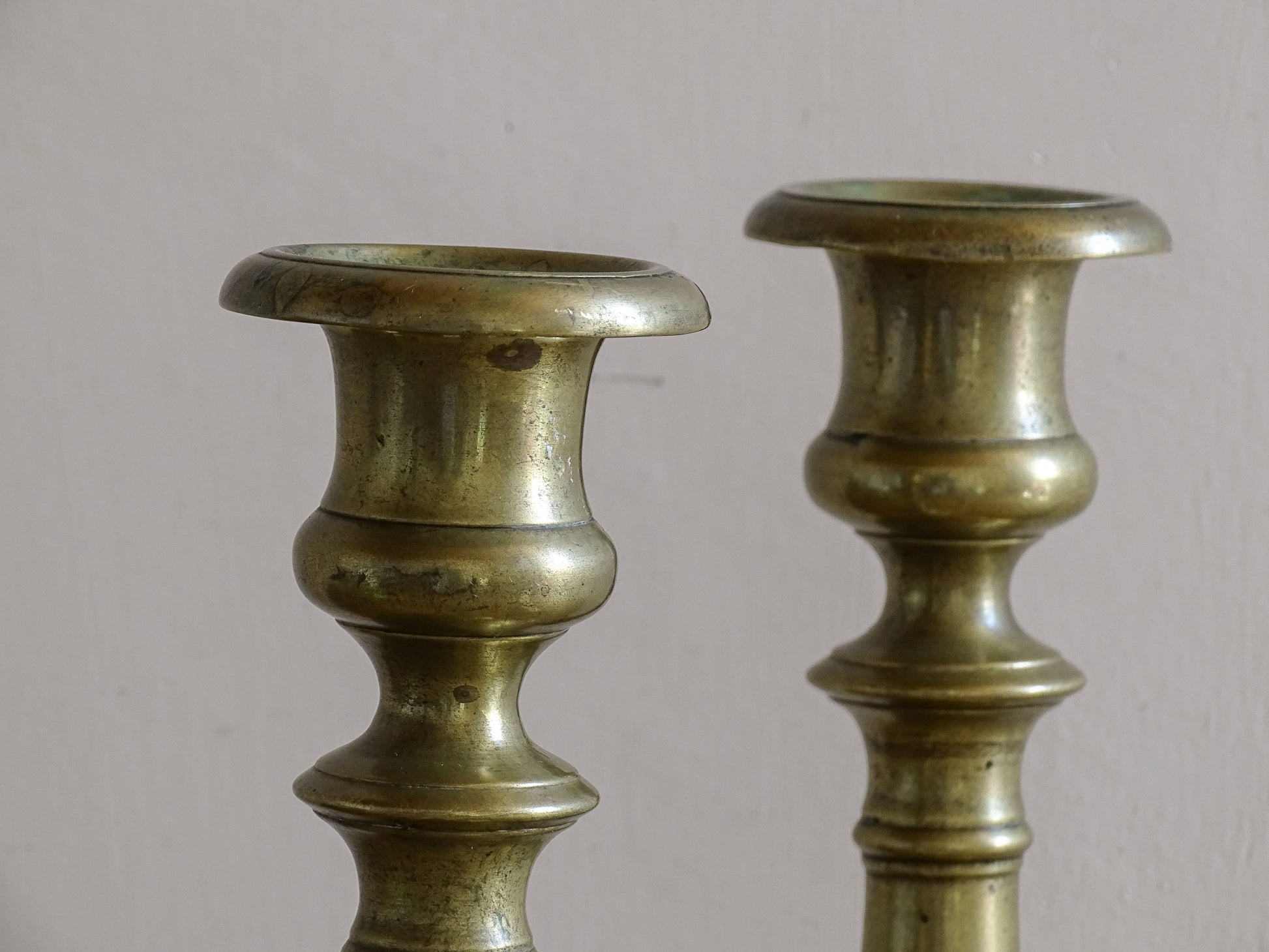 Early 20th century brass candlesticks with classic baluster stems.