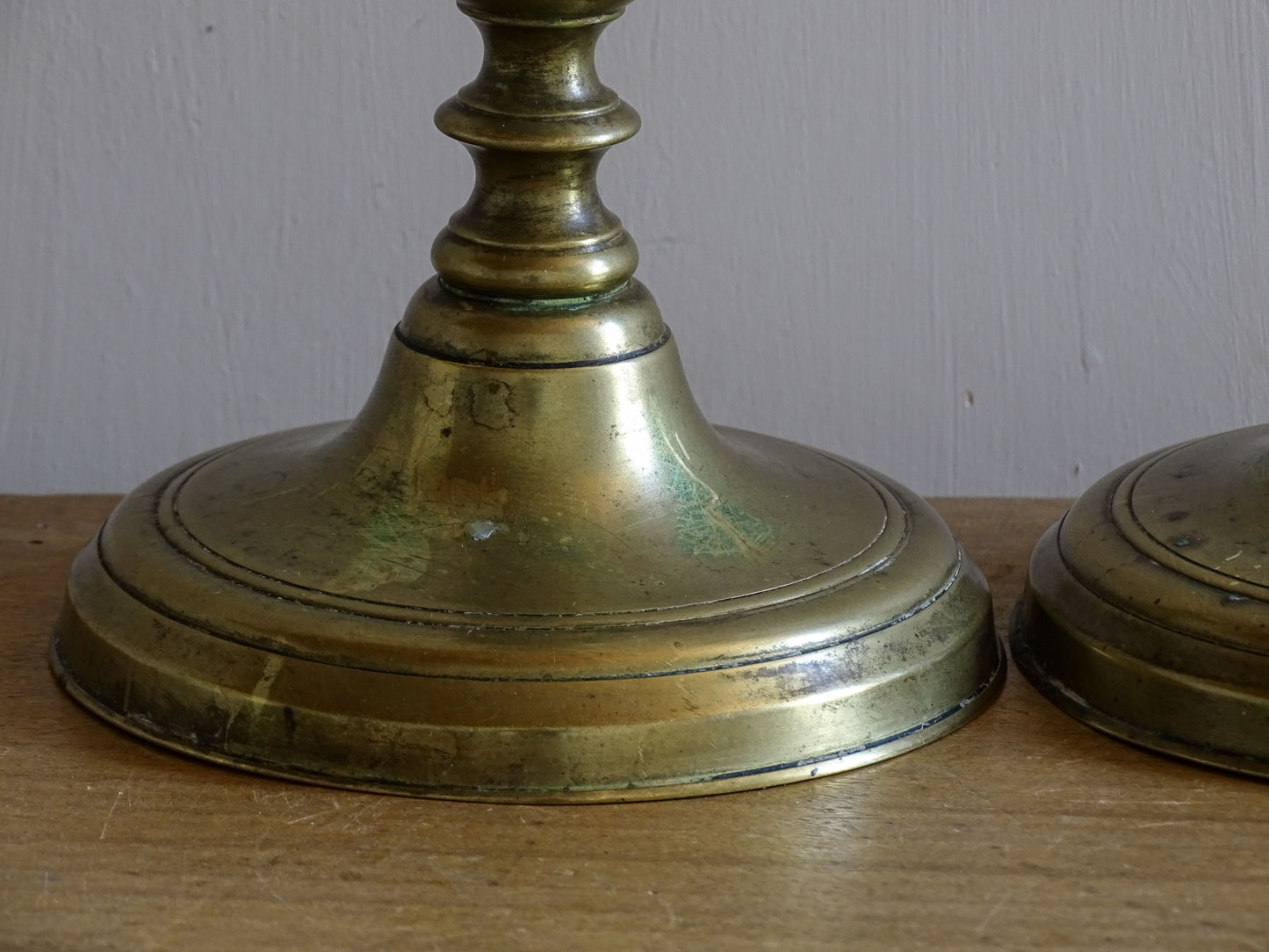 Detail of turned brass candlestick with aged antique finish.