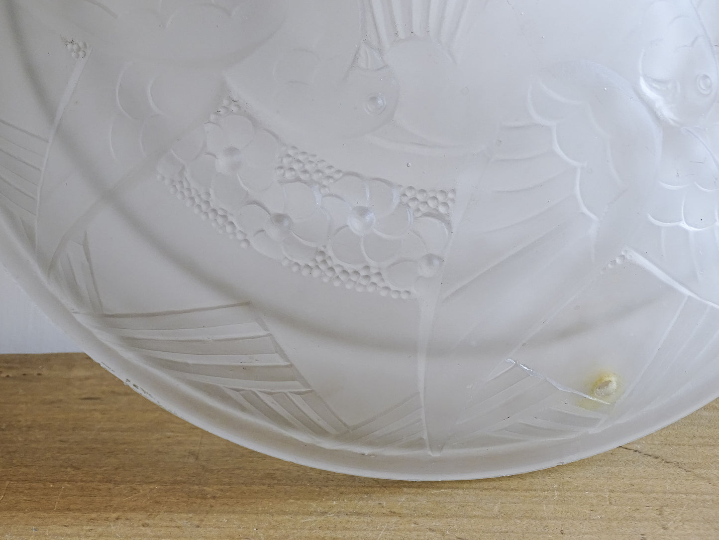 Detail of the original fixing hole on a French vintage frosted glass ceiling light shade.