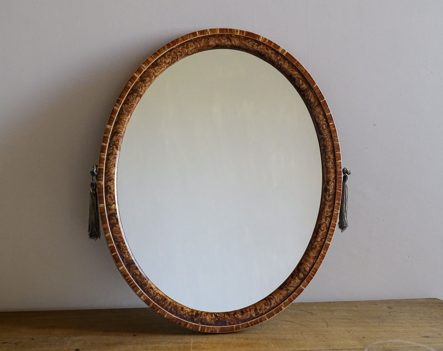 Mid-century French oval mirror with warm burr veneer frame