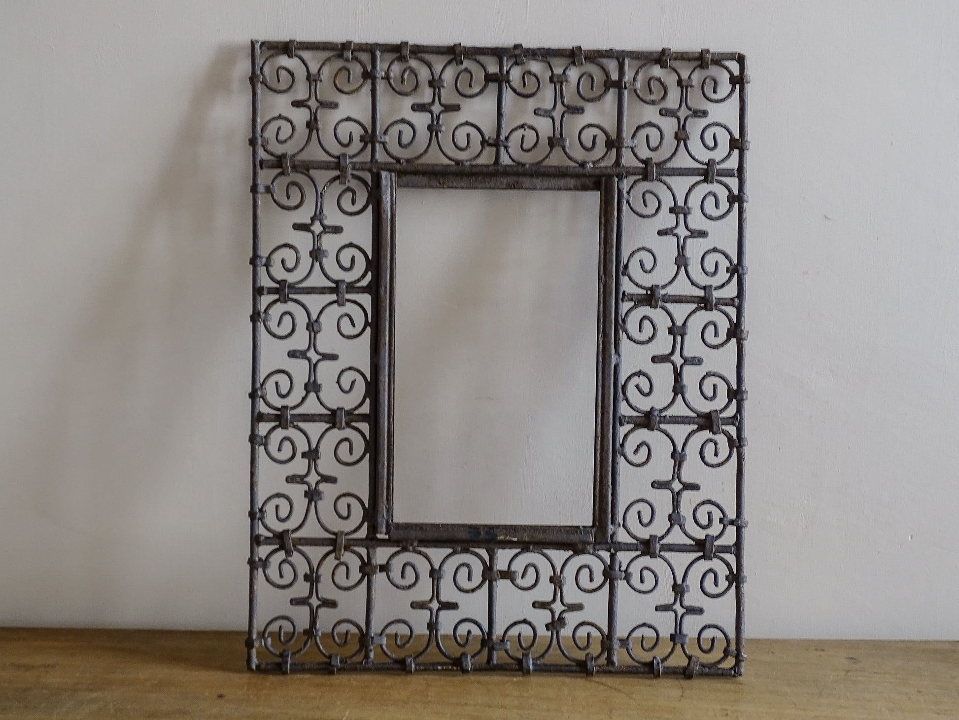 Decorative vintage wrought iron mirror frame with weathered patina