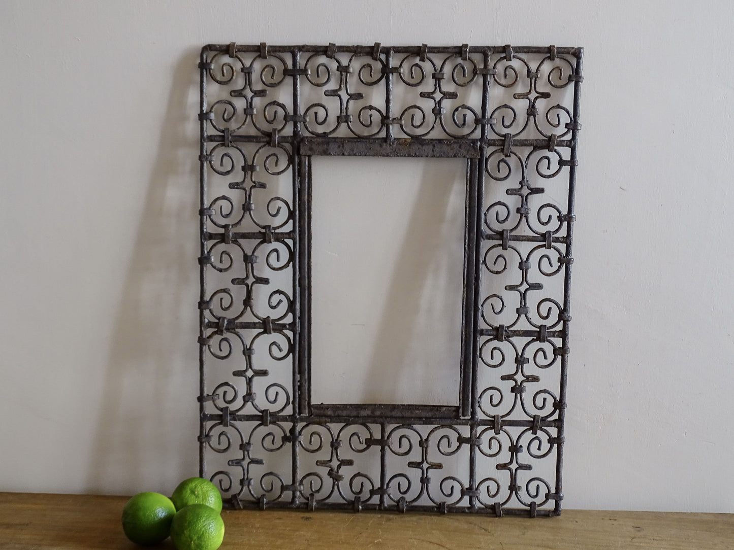 Vintage handcrafted Moroccan wrought iron mirror frame with decorative scrollwork