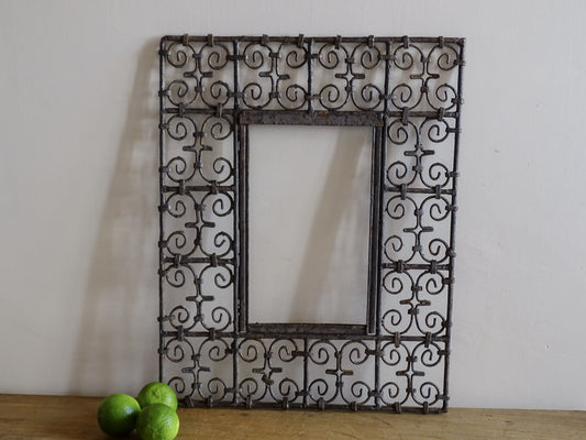 Vintage handcrafted Moroccan wrought iron mirror frame with decorative scrollwork