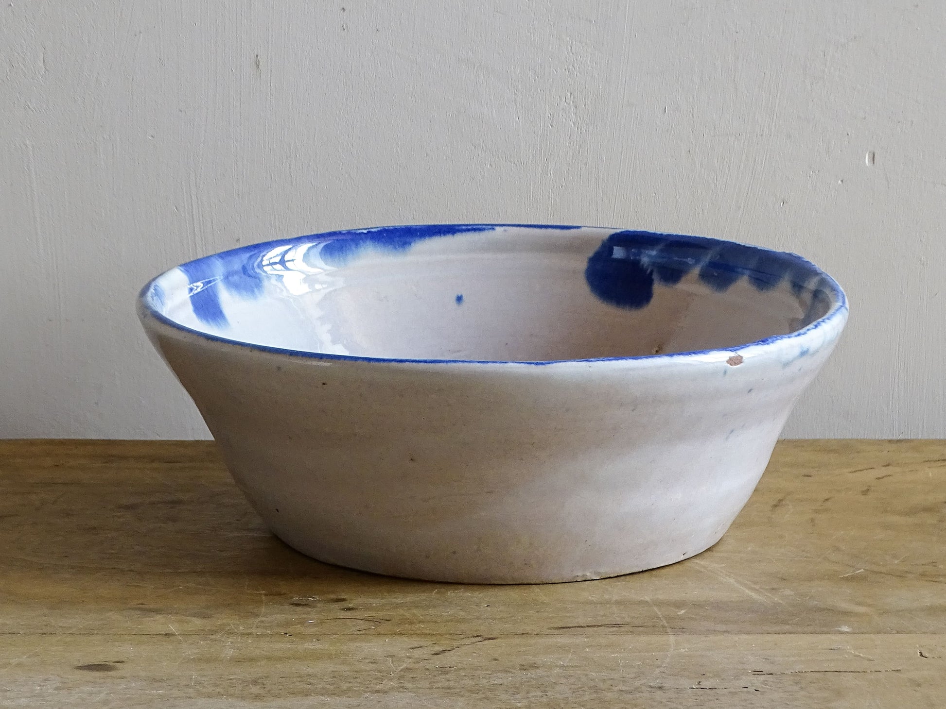 Vintage Fajalauza pottery bowl shown front-on, decorated with a large hand-painted cobalt blue flower.