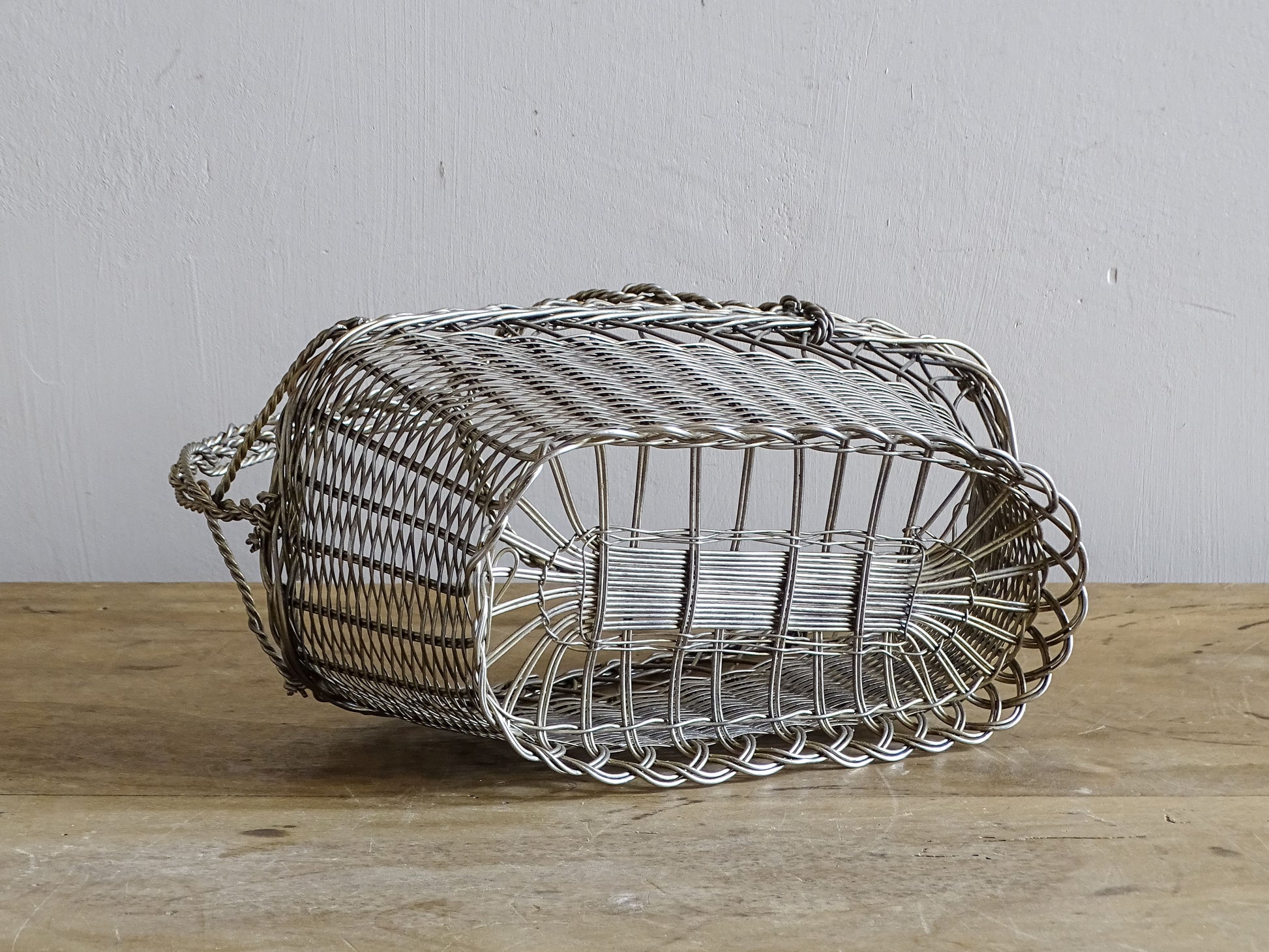French vintage wire wine bottle carrier with twisted handle.