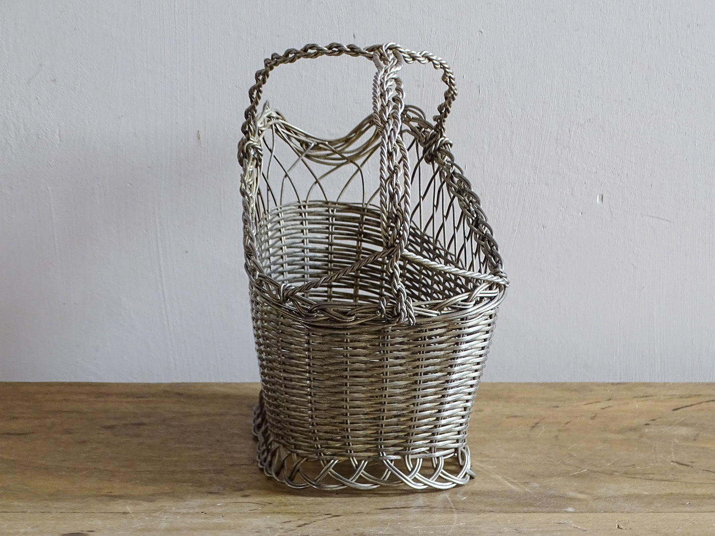 French vintage wire wine bottle carrier with twisted handle.