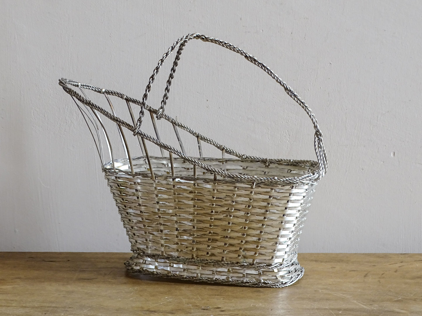 A French vintage silver-tone  woven wire wine basket or bottle carrier. 