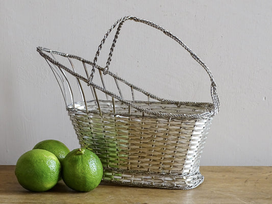 A French vintage silver-tone  woven wire wine basket or bottle carrier. 
