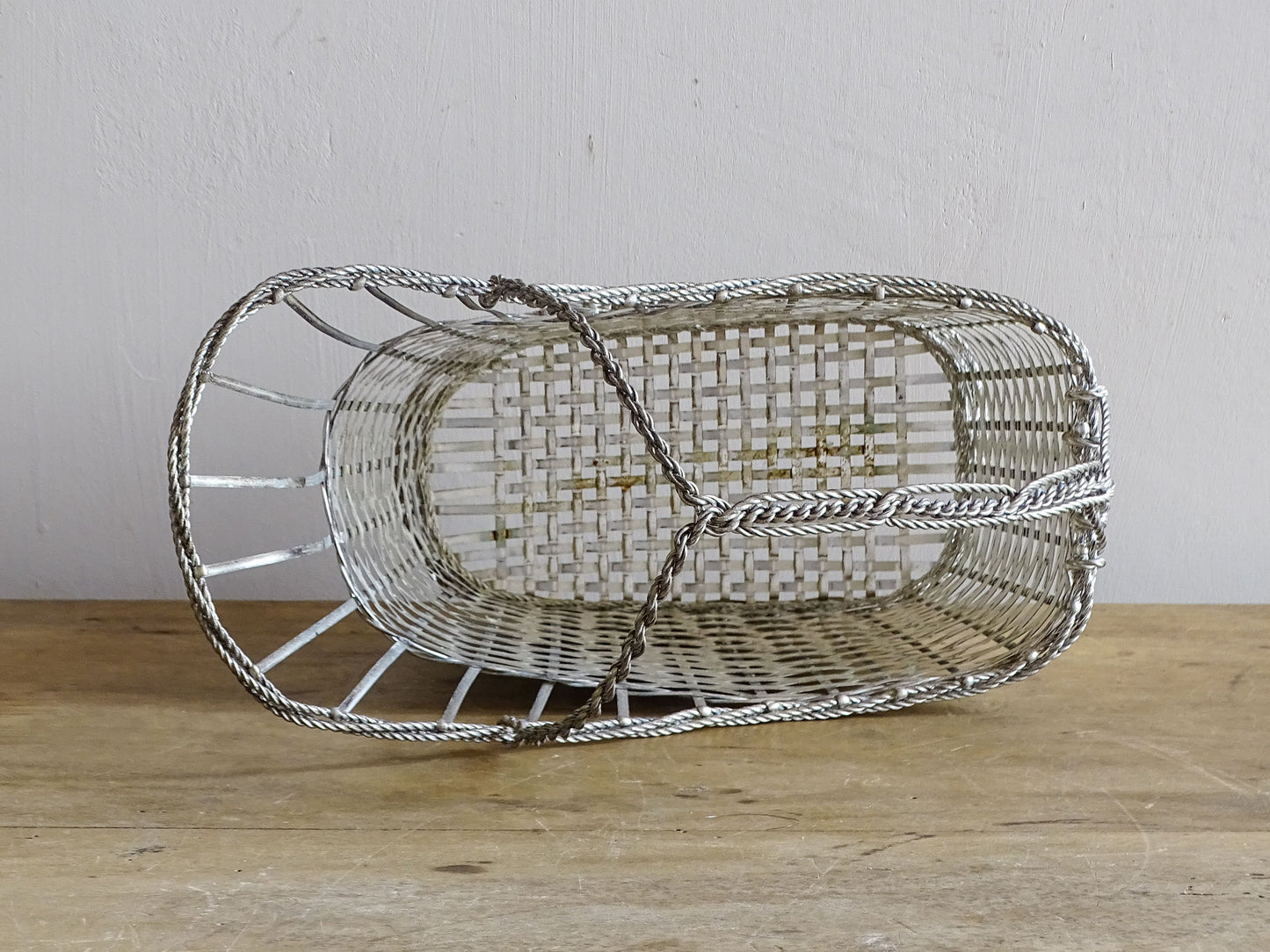 A French vintage silver-tone  woven wire wine basket or bottle carrier. 