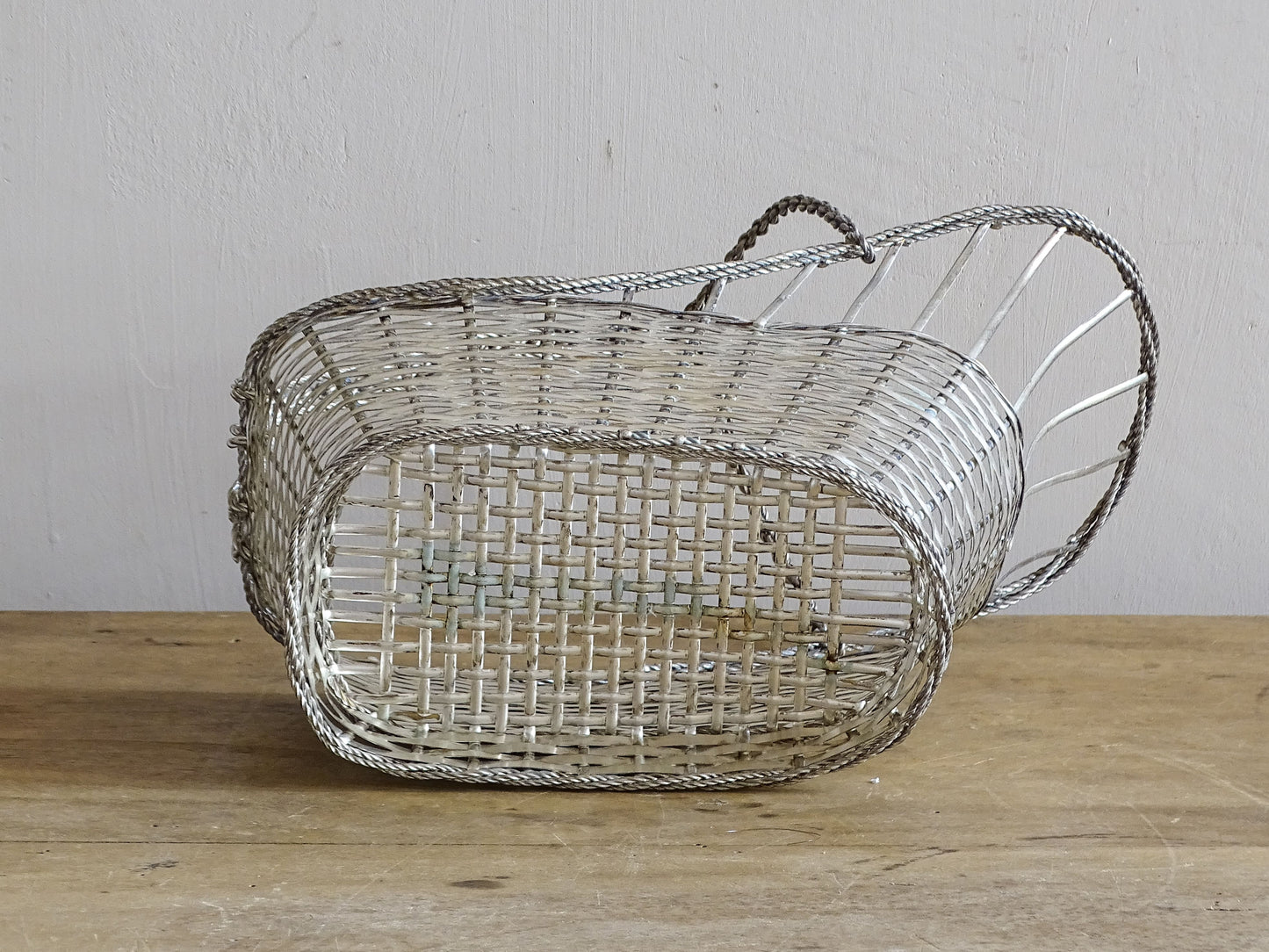 A French vintage silver-tone  woven wire wine basket or bottle carrier. 