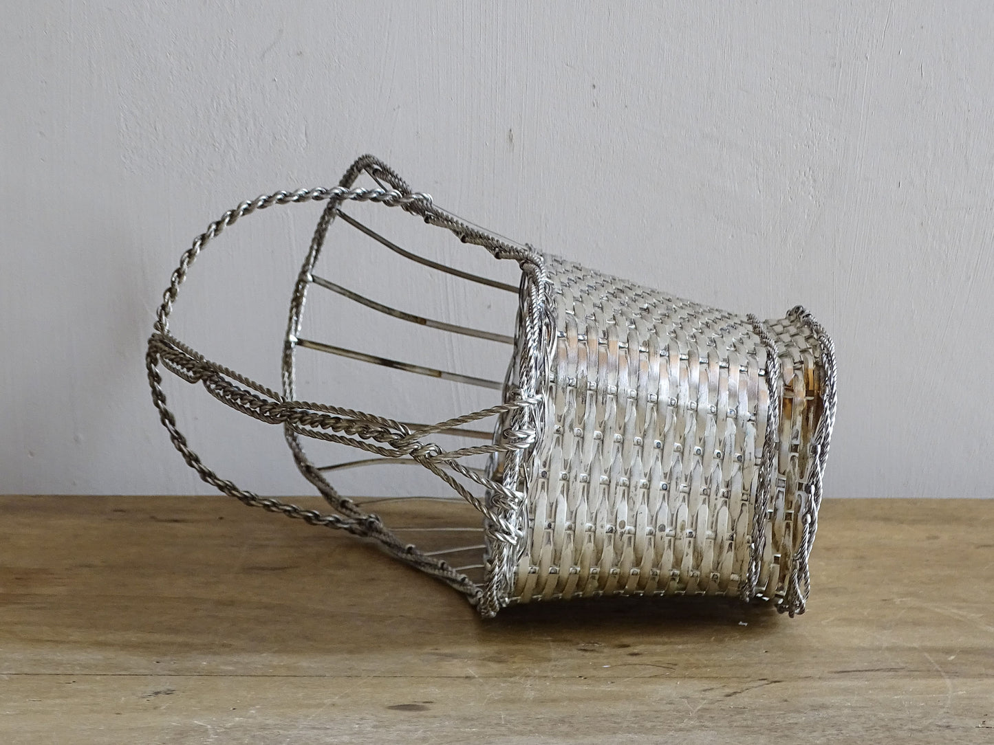A French vintage silver-tone  woven wire wine basket or bottle carrier. 