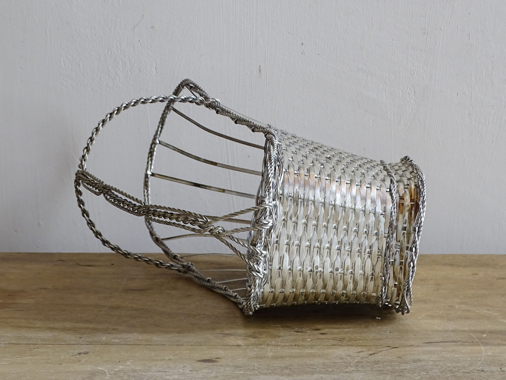 A French vintage silver-tone  woven wire wine basket or bottle carrier. 