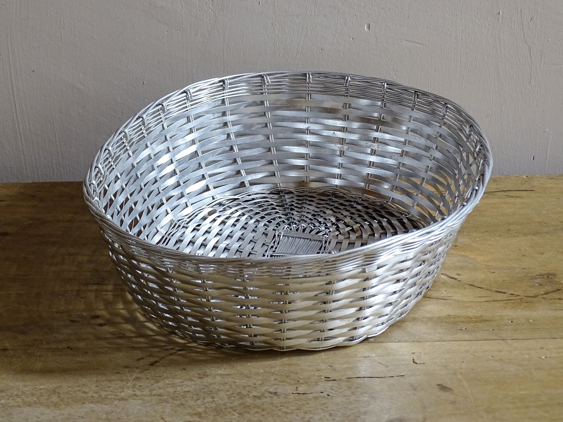 A French vintage silver coloured wire basket with an elegant elongated oval shape and finely woven construction.