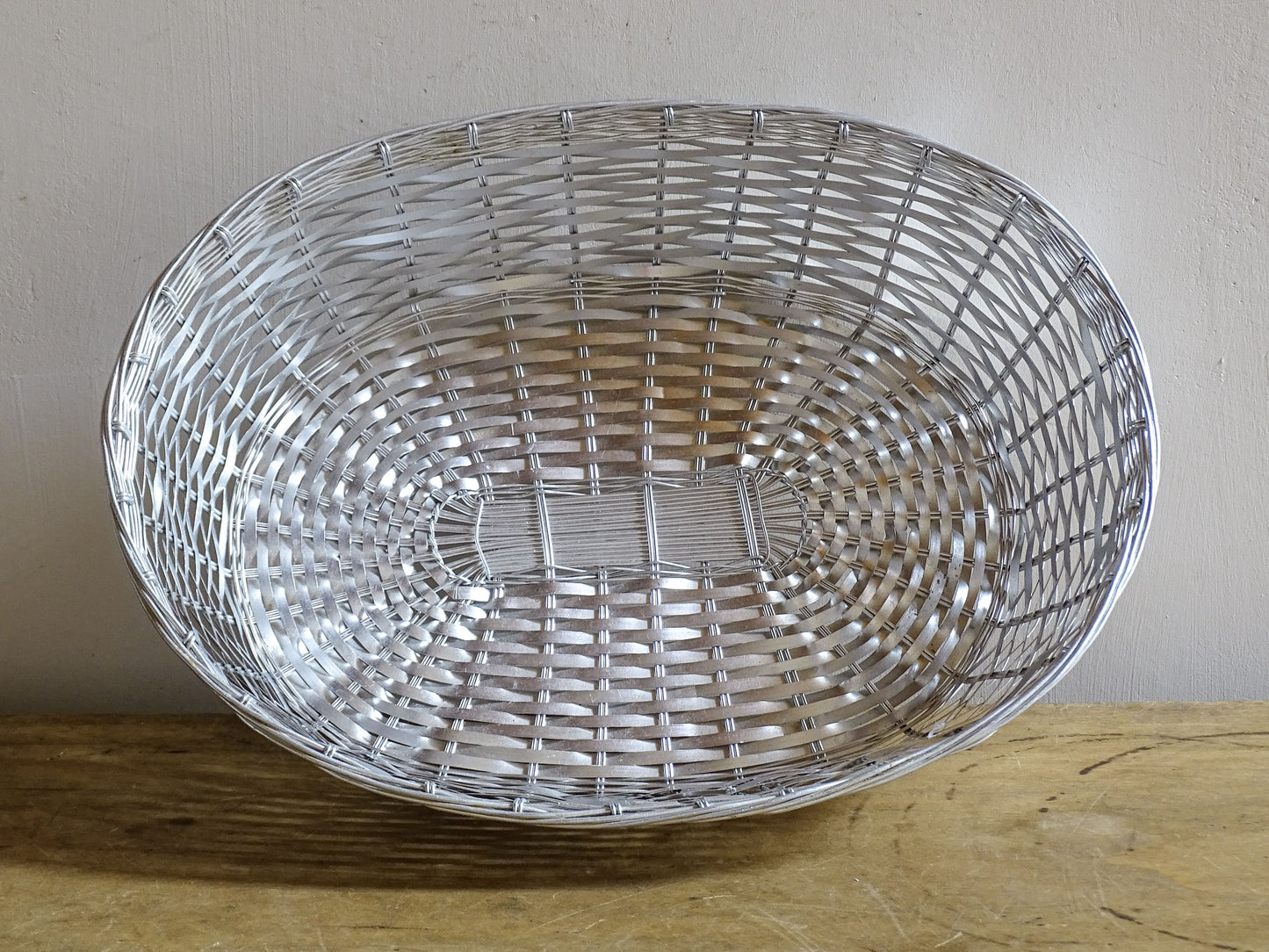 A French vintage silver coloured wire basket with an elegant elongated oval shape and finely woven construction.