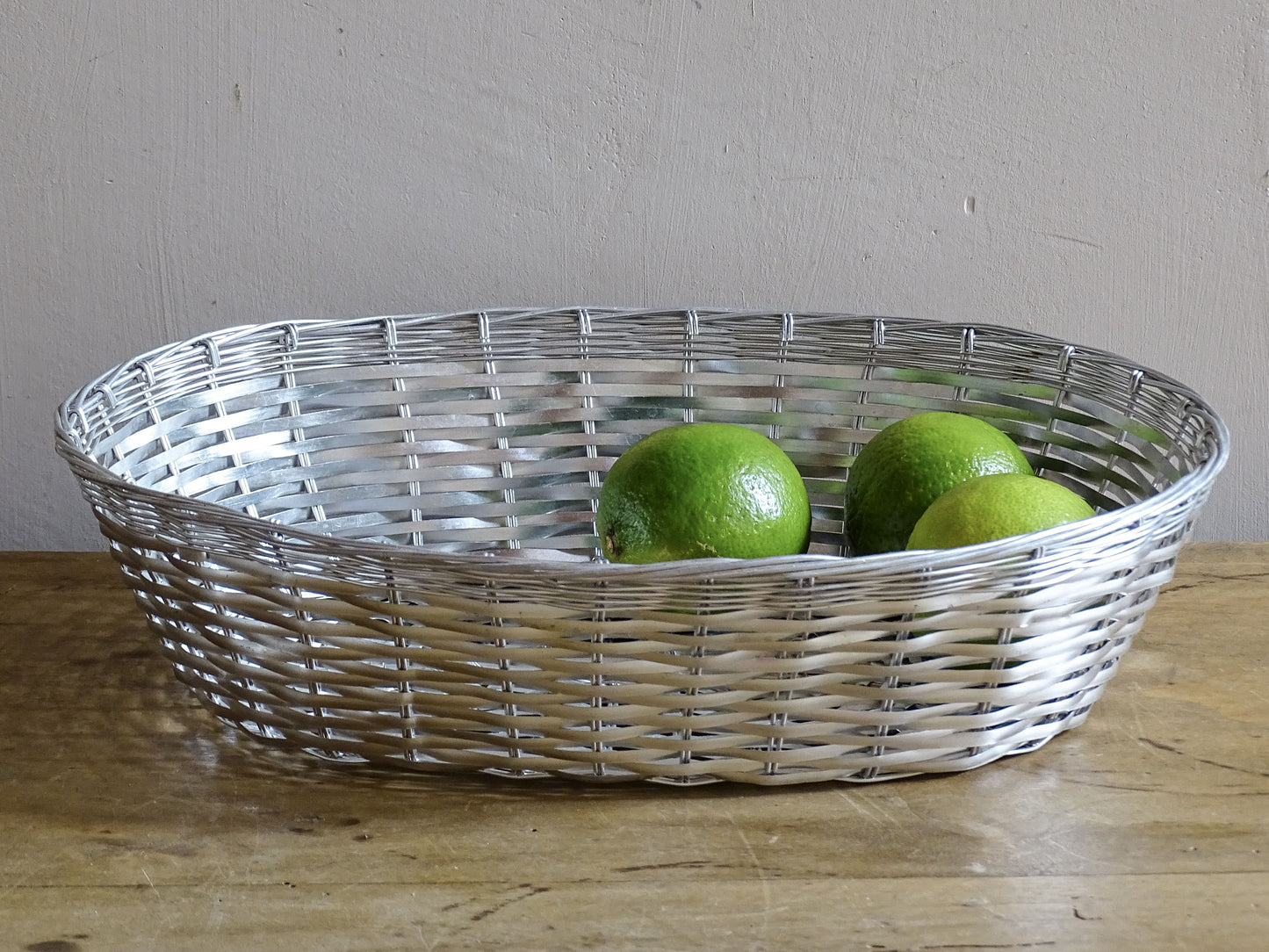 A French vintage silver coloured wire basket with an elegant elongated oval shape and finely woven construction.