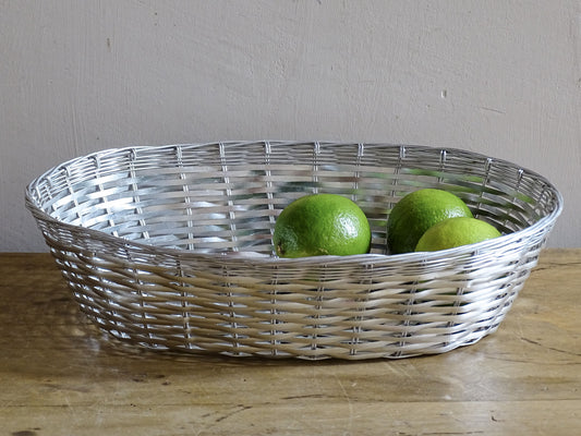 A French vintage silver coloured wire basket with an elegant elongated oval shape and finely woven construction.