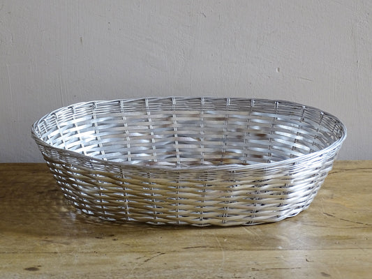 A French vintage silver coloured wire basket with an elegant elongated oval shape and finely woven construction.