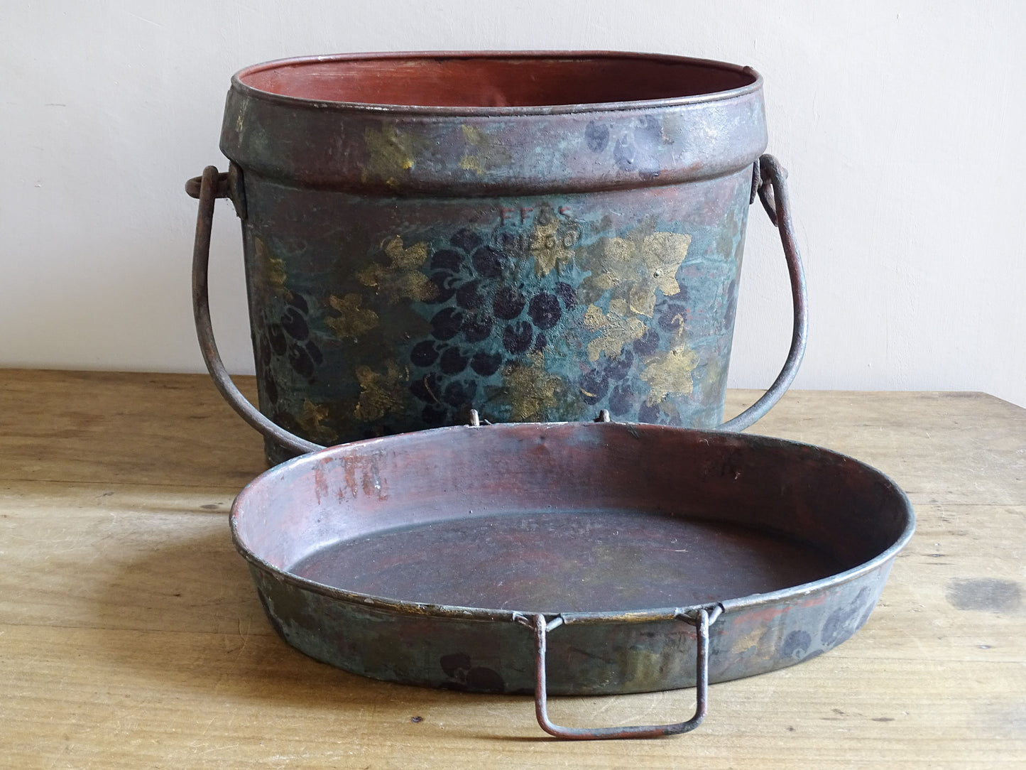 Large toleware storage box displayed open with its grape-decorated lid placed in front.