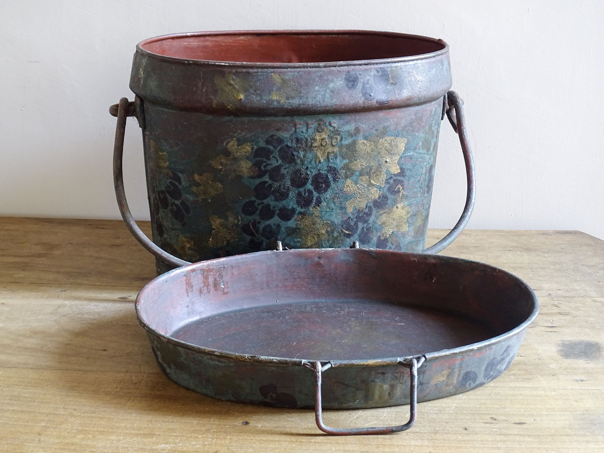 Large toleware storage box displayed open with its grape-decorated lid placed in front.