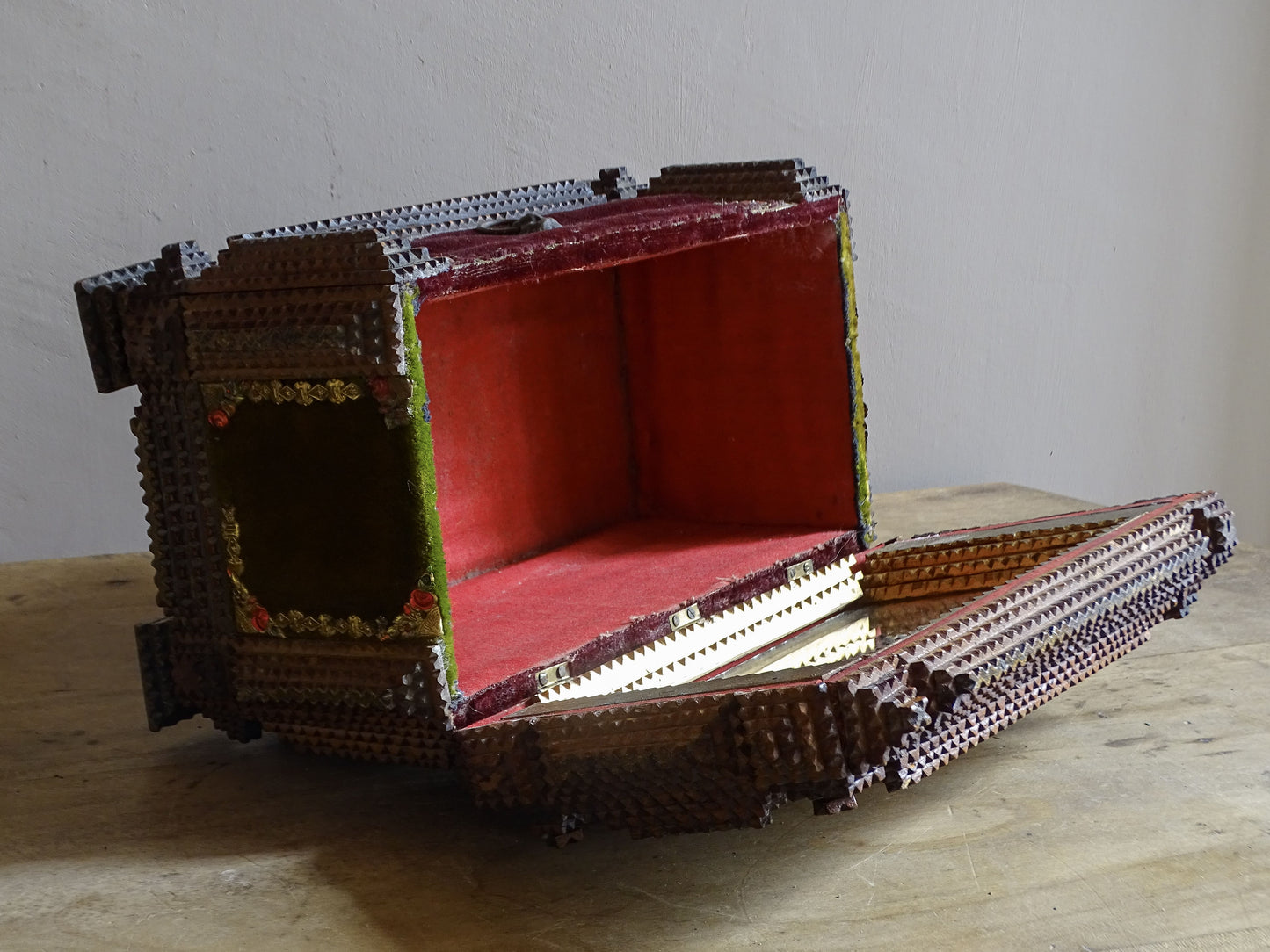 Interior view of antique tramp art box showing the red fabric lining.