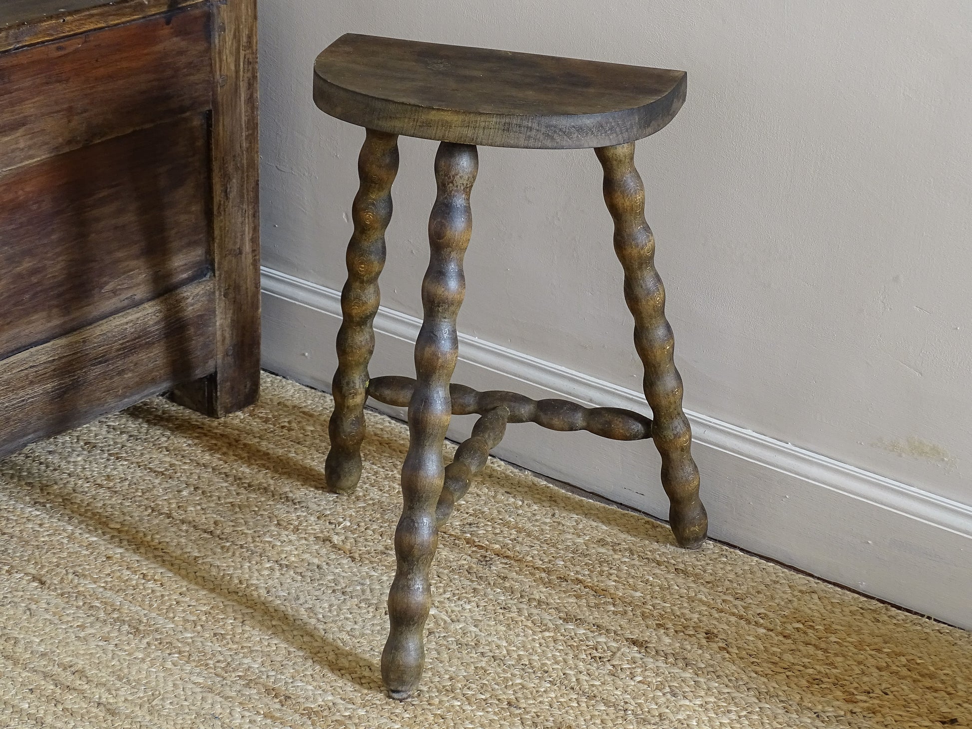 Rustic French wooden stool with a curved half-moon seat