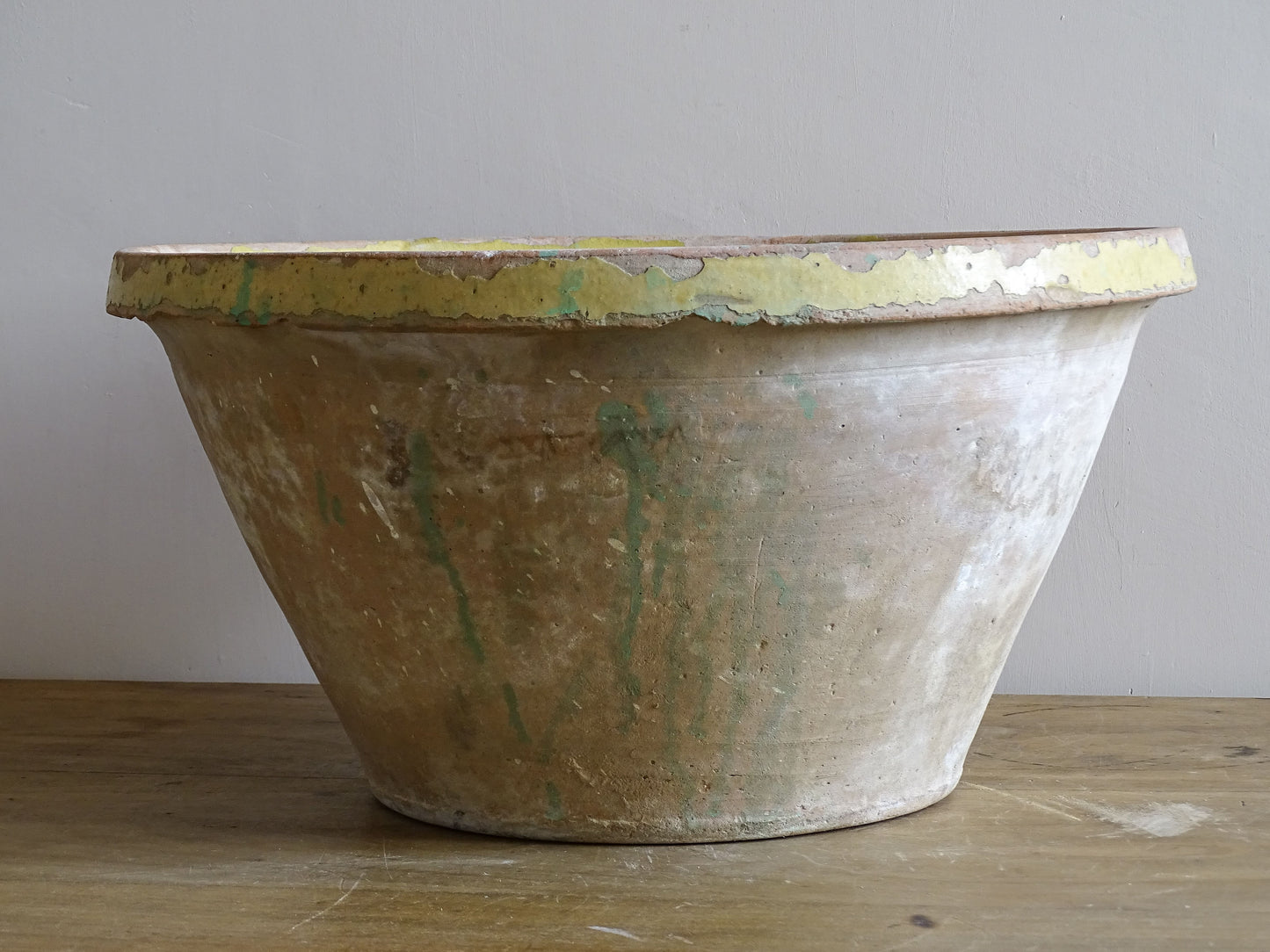 Large rustic French ceramic bowl with distressed yellow interior glaze