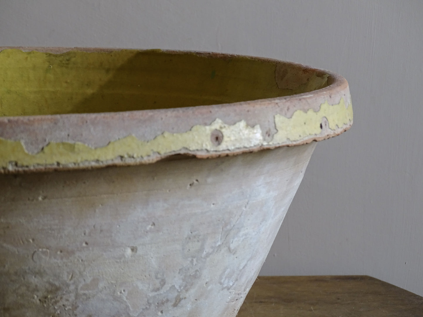 Large antique French tian bowl with worn mustard-yellow glaze