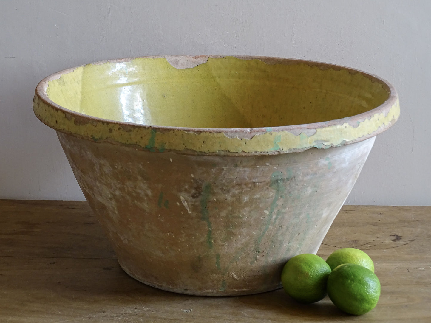 Weathered yellow-glazed French pottery bowl for country interiors