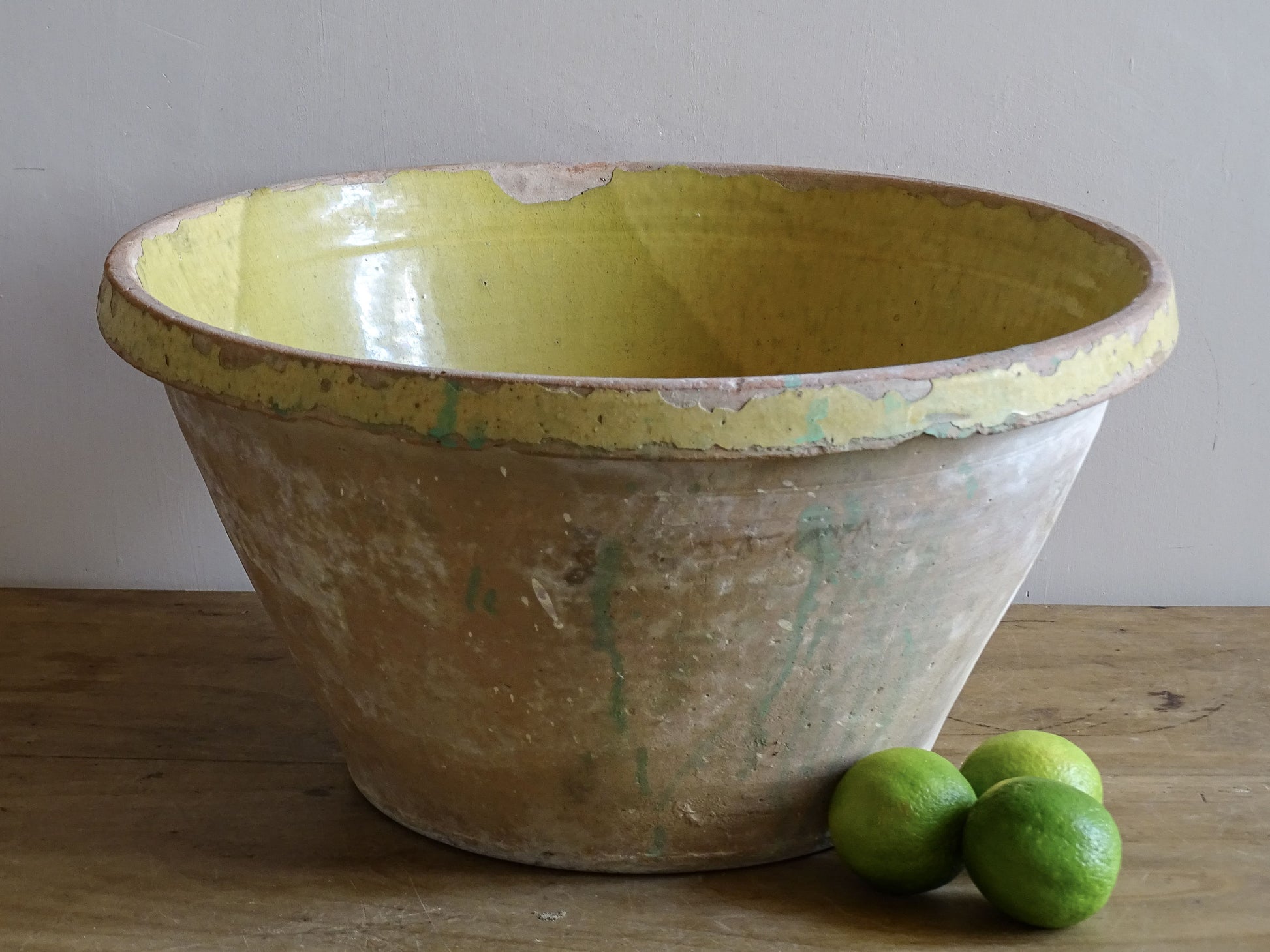 Weathered yellow-glazed French pottery bowl for country interiors