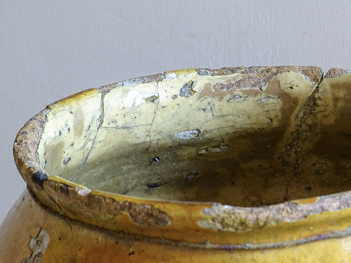 Rustic French confit pot with mustard yellow glaze, loop handles and aged patina