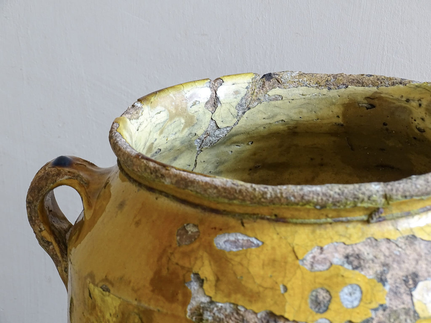 Rustic French antique confit pot with timeworn glaze