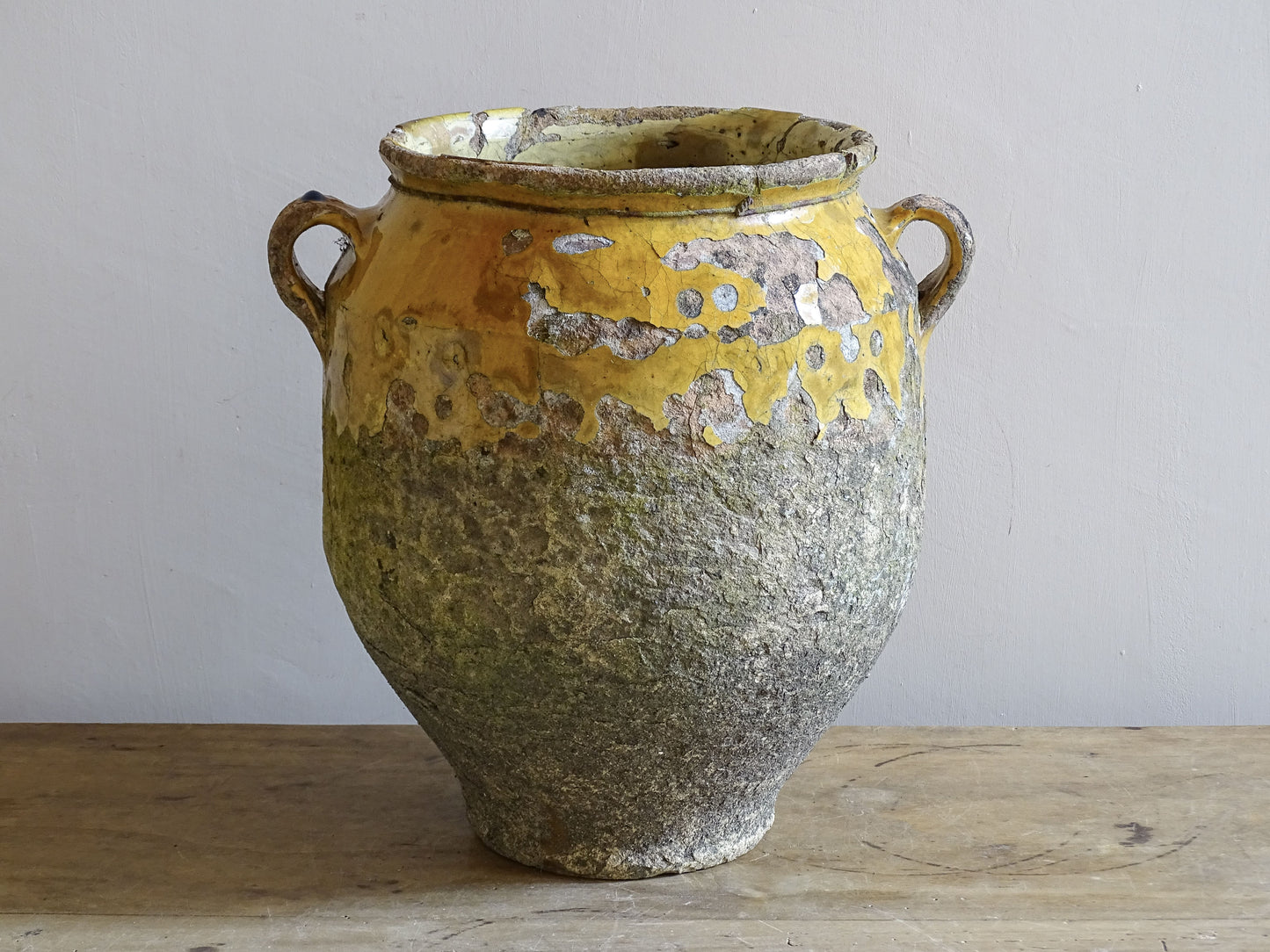 Rustic earthenware confit pot with yellow glaze 