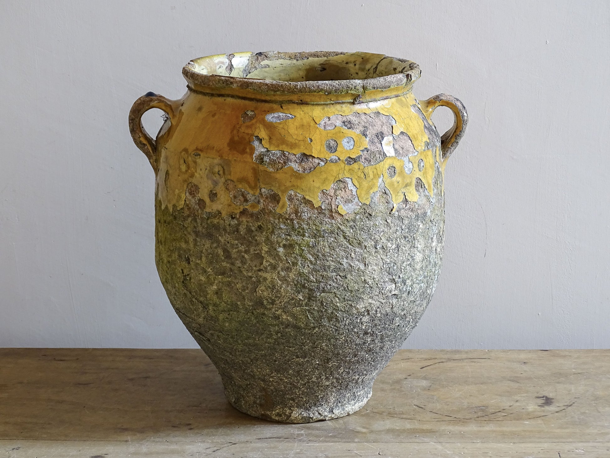 Rustic earthenware confit pot with yellow glaze 