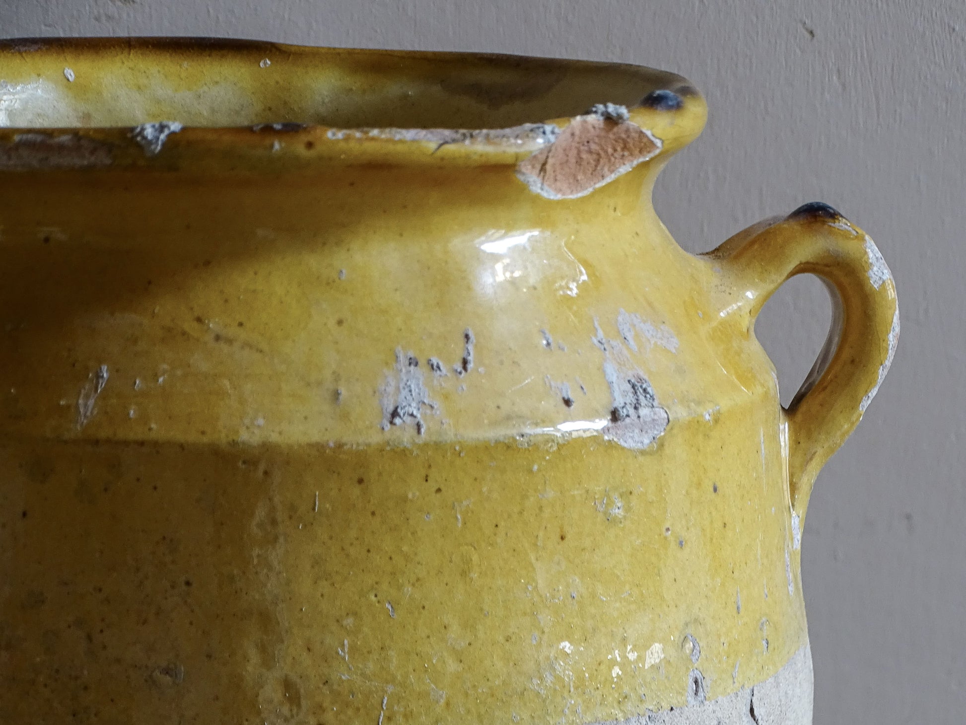 An antique French Confit Pot with Yellow Glaze and two looped handles.