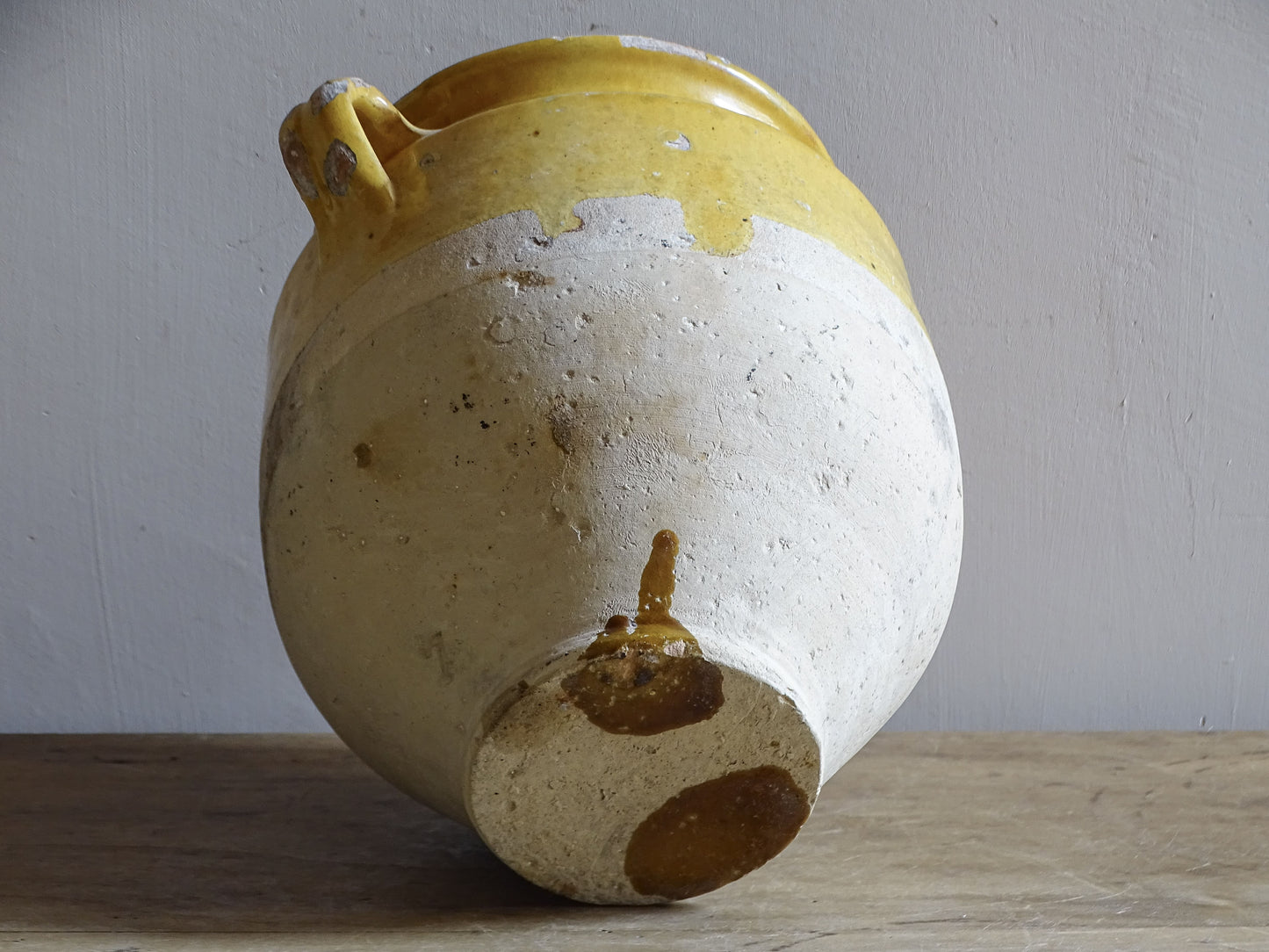 An antique French Confit Pot with Yellow Glaze and two looped handles.